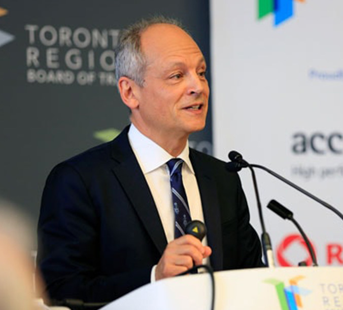 Meric Gertler speaks at a podium. Text behind him reads, Toronto Region Board of Trade.